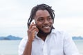 African american guy with dreadlocks and white shirt at phone Royalty Free Stock Photo