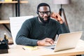 African-American guy with headset using laptop Royalty Free Stock Photo