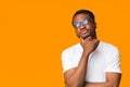 African American Guy Thinking Touching Chin Standing Over Orange Background Royalty Free Stock Photo