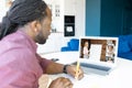 African-American guy using laptop computer for video call