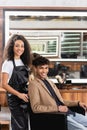 African american hairdresser in apron smiling