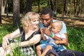 African American happy family: black father, mom and baby boy on nature. Royalty Free Stock Photo