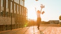 African American happy girl in city outdoors office company building silhouette in sunshine woman throwing papers away Royalty Free Stock Photo