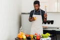 African man preparing healthy food at home in kitchen Royalty Free Stock Photo