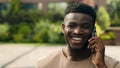 African American happy laughing smiling joyful man ethnic talking mobile phone guy laugh smile walking in city answer Royalty Free Stock Photo