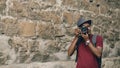 African american happy tourist taking photo on his dslr camera. Young man standing near famous building in Europe Royalty Free Stock Photo
