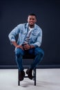 African American healthy male model in a cotton white t-shirt woth Jean jacket in studio summer lifestyle Royalty Free Stock Photo