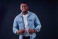 African American healthy male model in a cotton white t-shirt woth Jean jacket in studio summer lifestyle Royalty Free Stock Photo