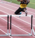 African American running the hurdles race on a track