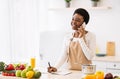 African American Housewife Cooking And Talking On Phone At Home Royalty Free Stock Photo