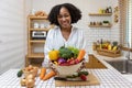 African American housewife is showing variety of organic vegetables to prepare simple and easy cajun southern style salad meal