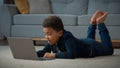 African American kid boy ethnic school pupil studying online from home watching web class lesson video call e-learning Royalty Free Stock Photo