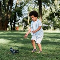 African american kid gesturing while looking at pigeon