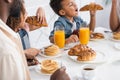 african american kids eating croissants for Royalty Free Stock Photo