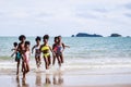 African American, Kids group in swimwear enjoying running to play the waves on beach. Ethnically diverse concept. Having fun after