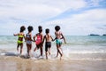 African American, Kids group in swimwear enjoying running to play the waves on beach. Ethnically diverse concept. Having fun after Royalty Free Stock Photo