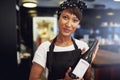 African American lady presenting a bottle of wine Royalty Free Stock Photo