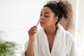 African American Lady Shaving Upper Lip Hair In Bathroom