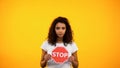 African-American lady showing stop sign, women rights protection, feminism