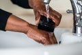 African American Lady washing her hands