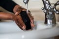 African American Lady washing her hands Royalty Free Stock Photo