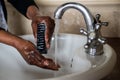 African American Lady washing her hands