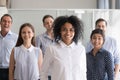 African American leader, coach posing with multiracial group of Royalty Free Stock Photo