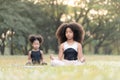 African American little girl sitting on the roll mat practicing meditate yoga in the park outdoor Royalty Free Stock Photo