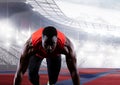 African american male athlete on starting position at running track against sports stadium Royalty Free Stock Photo