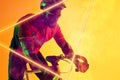 African american male athlete wearing helmet and eyewear riding bike by illuminated triangle