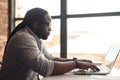 African-American male author typing on a laptop