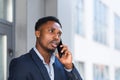 African American male businessman angry talking on mobile phone outside. Business man having phone call outdoors. Nervous mad Royalty Free Stock Photo