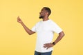 African American Male Doing Finger Snap Gesture Over Yellow Background