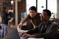 African american male employee working with asian woman Royalty Free Stock Photo