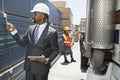 African American male engineer inspecting planks while female worker standing by flatbed truck Royalty Free Stock Photo