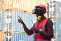 African-American male engineers wearing VR Headset look container cargo ship