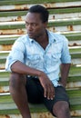 African american male fashion model sitting on stairs Royalty Free Stock Photo