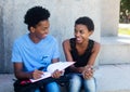 African american male and female student learning for exam Royalty Free Stock Photo