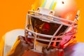 African american male american football player wearing helmet with neon orange lighting