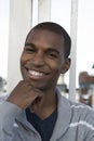 African American male model smiling hand on his chin Royalty Free Stock Photo