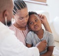 African american male paediatrician examining sick boy with stethoscope during visit with mom. Doctor checking heart Royalty Free Stock Photo