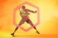 African american male player playing tennis over illuminated hexagon on gradient background