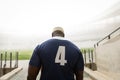 African American male rugby player entering stadium for match