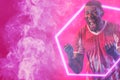 African american male soccer player screaming on smoky pink background, copy space