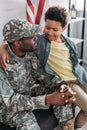 African american male soldier embracing