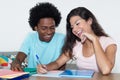 African american male student learning with caucasian female stu Royalty Free Stock Photo