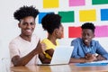 African american male student showing thumb up at computer with group of students Royalty Free Stock Photo