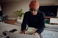 African American male working from home on his laptop. African American male planning week with paper and pen