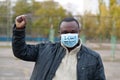 African american man activist in medical mask with an inscription I CANT BREATHE