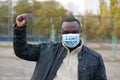 African american man activist in medical mask at single picket